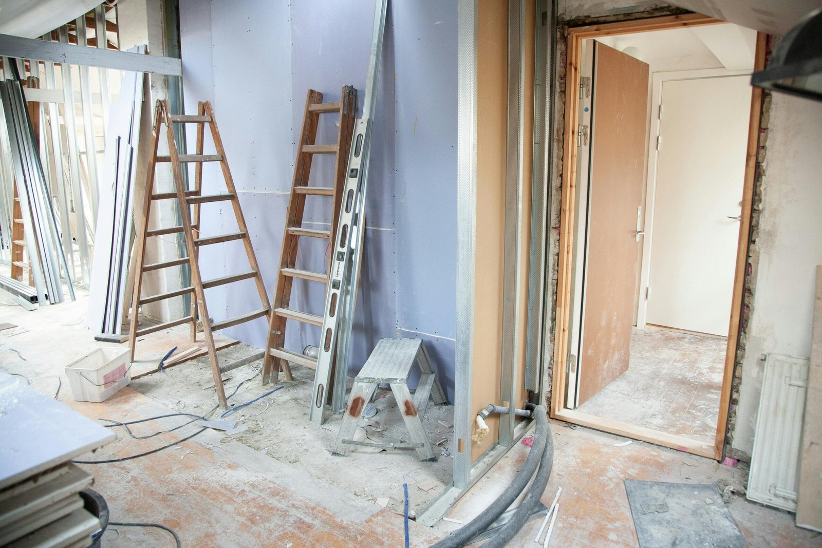Home Construction site featuring ladders and tools in a home renovation setting.